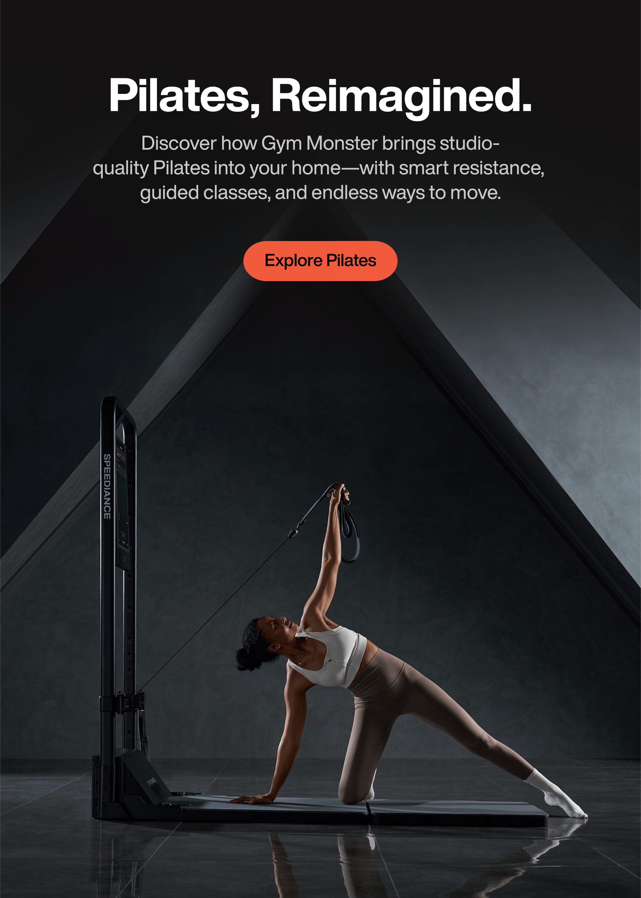 A woman in a white sports bra and beige leggings performs a Pilates pose using a black GYM MONSTER Pilates machine in a dark studio setting. White promotional text at the top reads 'Pilates, Reimagined.