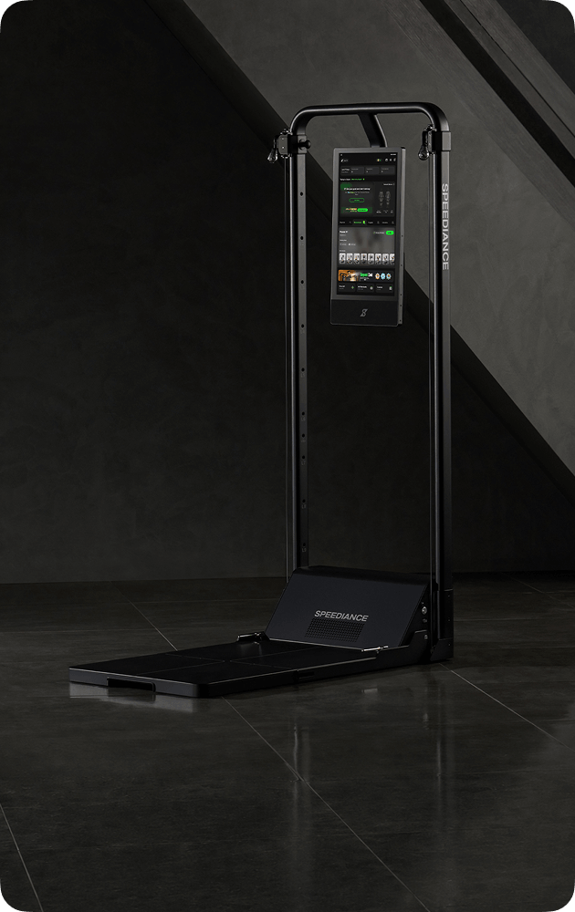 Black exercise machine with digital display on a dark floor