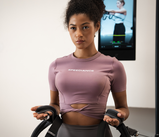 Adult wearing a wrist tracker during an indoor exercise session