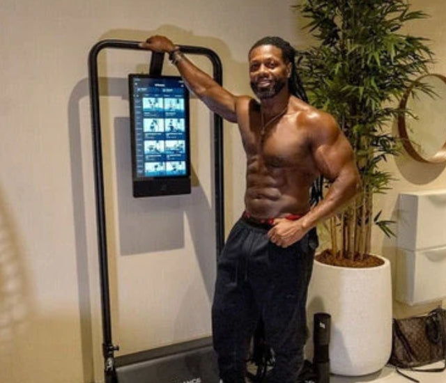 Ulisses Jr. posing next to the Speediance Gym Monster 2
