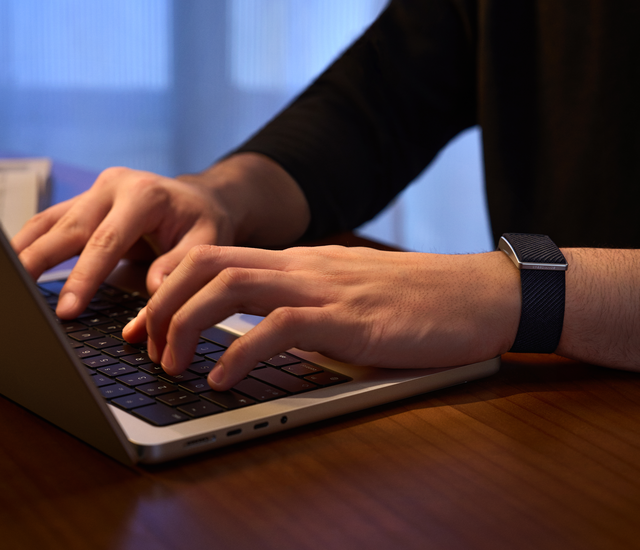 Two screen-free wrist trackers and a reference chest strap arranged on a table