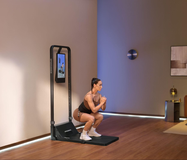 Woman performing squat with cable machine