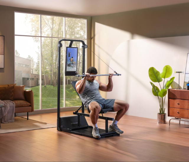 Man performing pull downs on Speediance Gym Monster 2