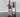 An individual performs a standing dual-handle drag curl