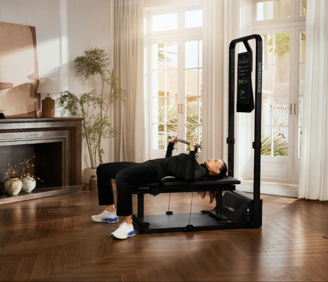 Woman performing bench press on Speediance Gym Monster 2