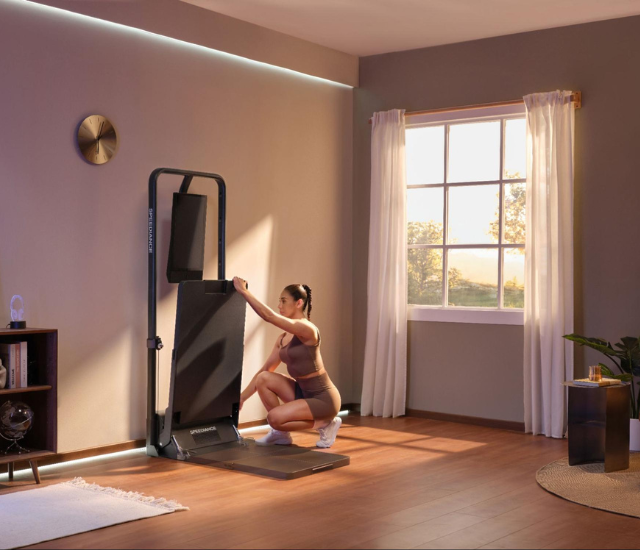 Woman setting up Speediance Gym Monster 2 at home
