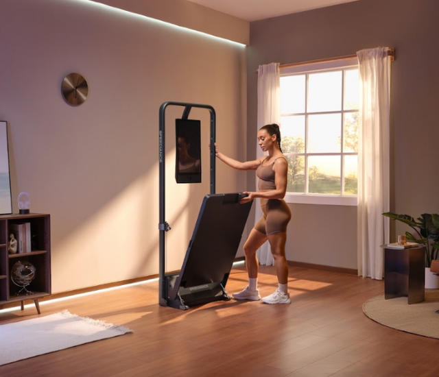 An individual adjusting their Speediance Gym Monster 2 in their home gym