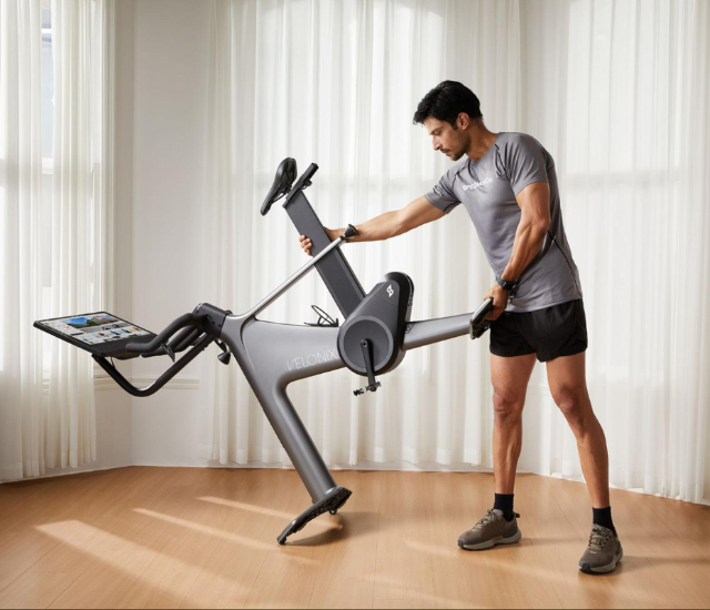 Man setting up Speediance VeloNix indoor bike