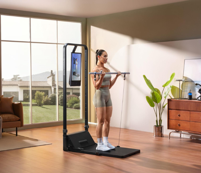 Woman using the Speediance Gym Monster 2 with barbell