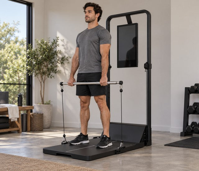 Athlete holding a straight cable bar at the top of a deadlift on a Speediance Gym Monster 2