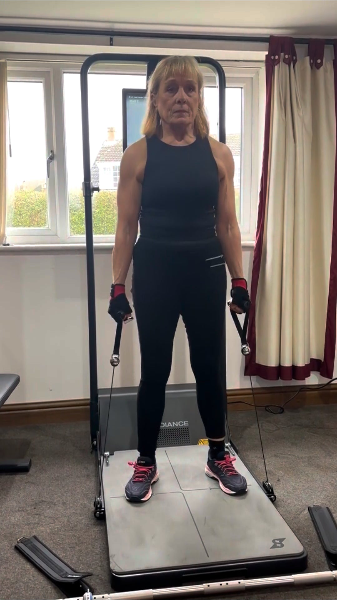 Person exercising using a cable machine in a home setting