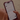 Person holding a smartphone displaying a health app with body composition data.