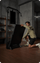 Person setting up a black exercise machine in a room with a television on the wall.