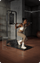 Woman exercising on a pull-up bar in a gym setting