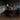 Person using a home gym machine in a dimly lit room.